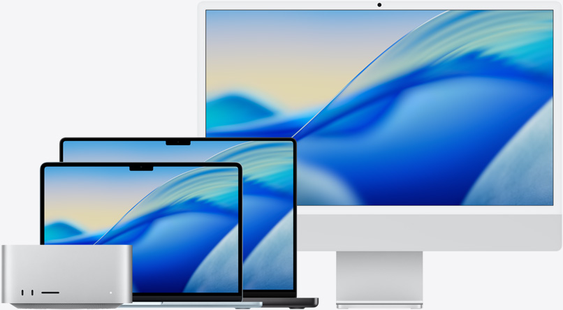 The macOS Tahoe wallpaper across family of Mac models from left to right: Mac Studio, 13-in MacBook Air in Sky Blue, 14-in MacBook Pro in Space Black, and 24-in iMac in Silver